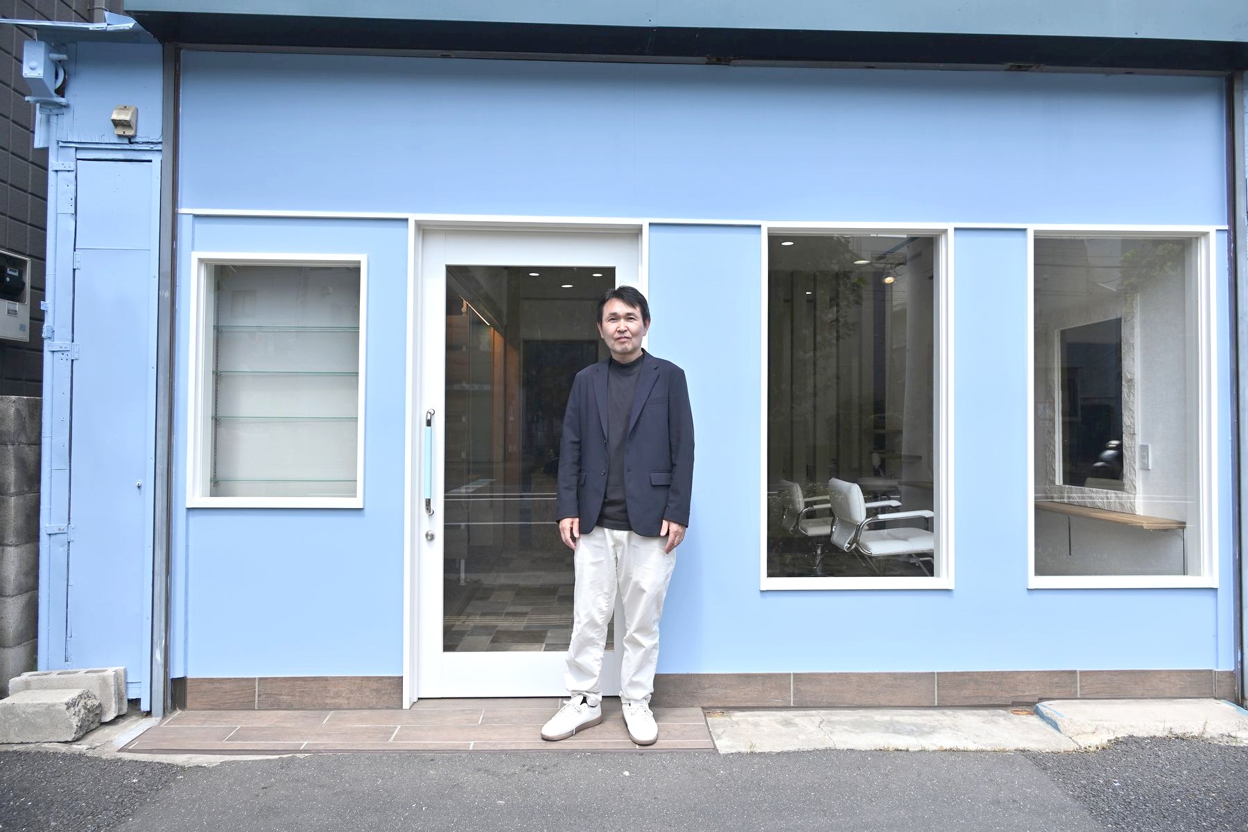 店の前に立つ根本博幸さん